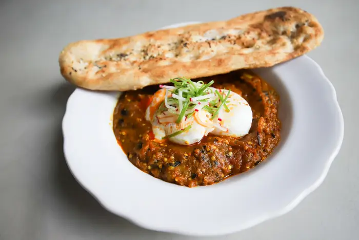 Smoked Eggplant: charred eggplant and slow roasted tomato garlic sauce, poached eggs, house bread<br/>